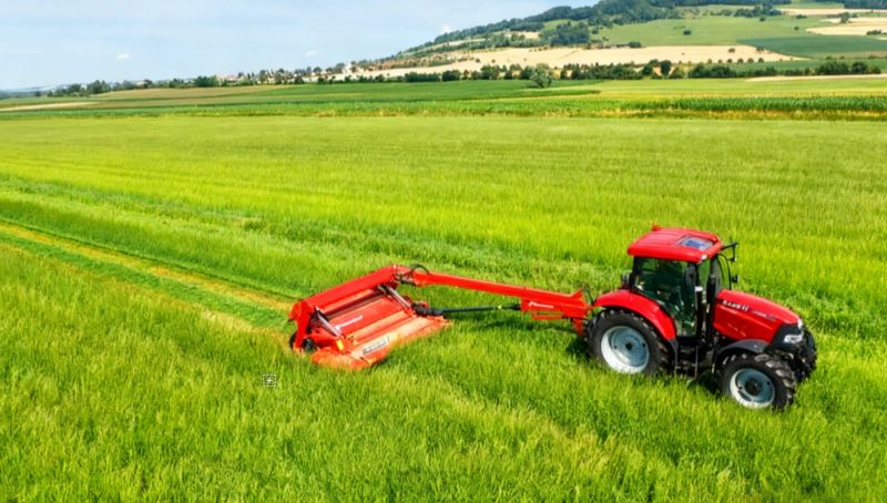 A mower and baler is used for harvesting grassy forage on a ranch.
