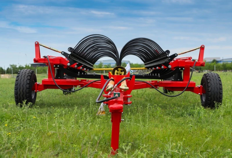 9LH-12 Horizontal Hay Rake 12-metre wide side-delivery towed configuration showing full tine arm span hydraulic fold system and windrow formation on large commercial grassland operation